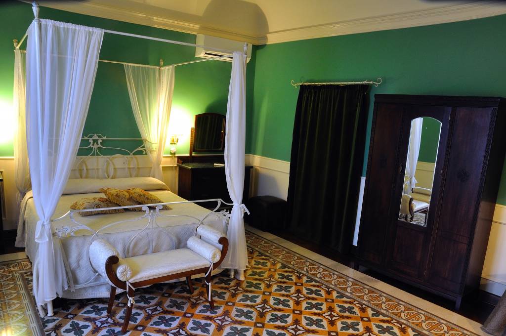 Elegant bedroom at Relais Briuccia on a Sicily cooking vacation