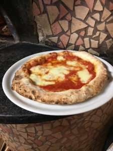 Enjoying a Neapolitan pizza during a Naples food tour.