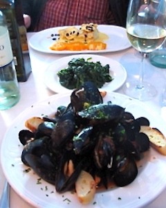 Enjoying a meal with mussels on our Sicily cooking vacations.