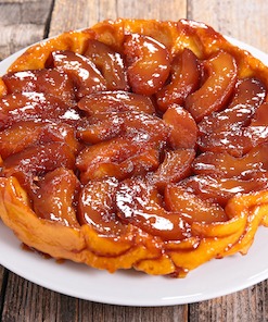 Enjoying tarte tatin on a cooking vacation in Provence.